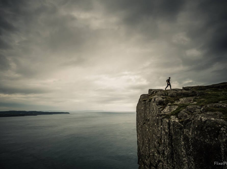 a person walking on a cliff edge