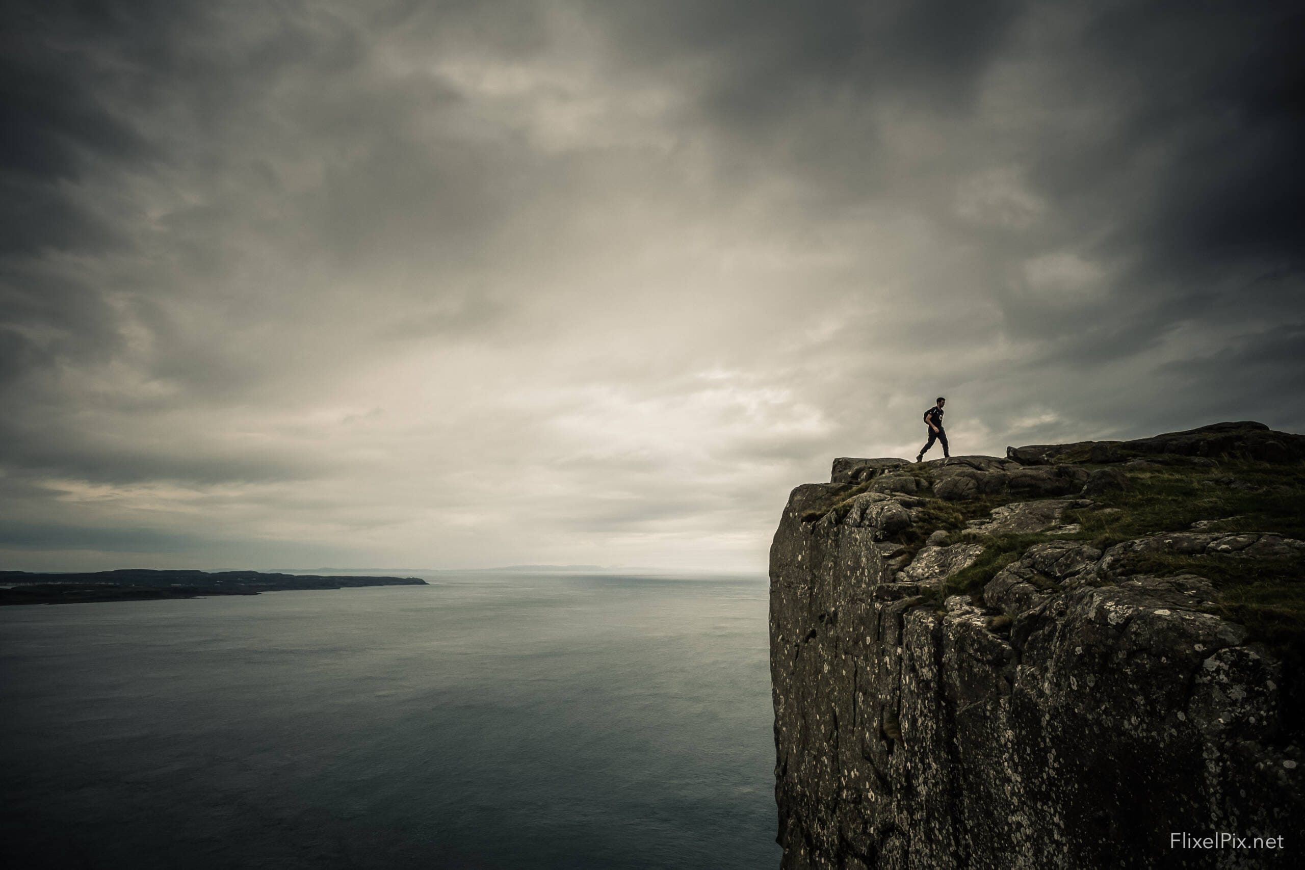 a person walking on a cliff edge